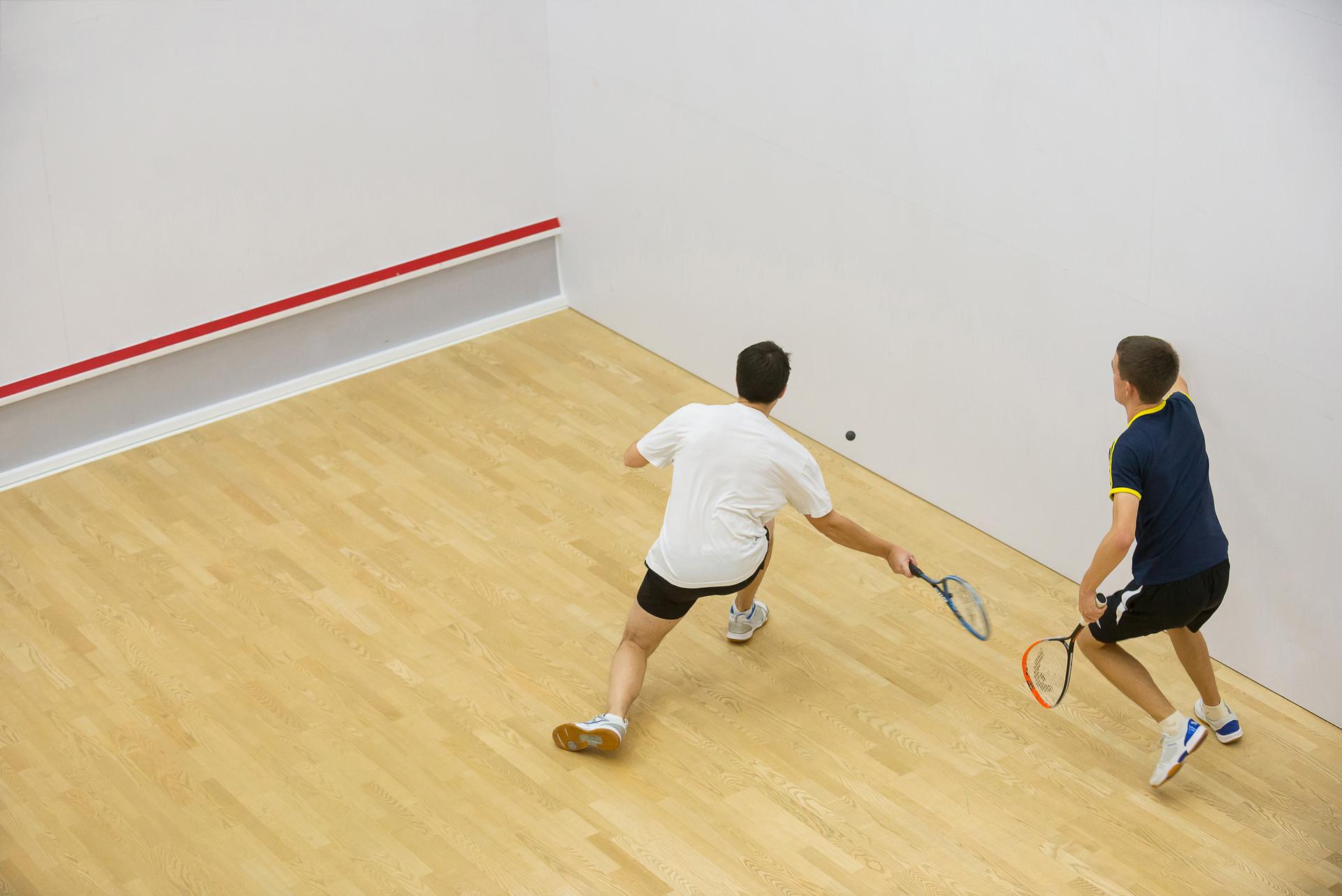 Two men playing match of squash.